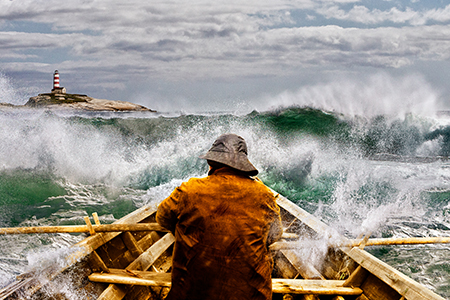 Image of a sailor in a boat, sailing in the sea