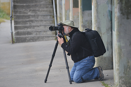 Photographer with tripod. Photographer demonstrating camera handling technique at a state park in Washington State.